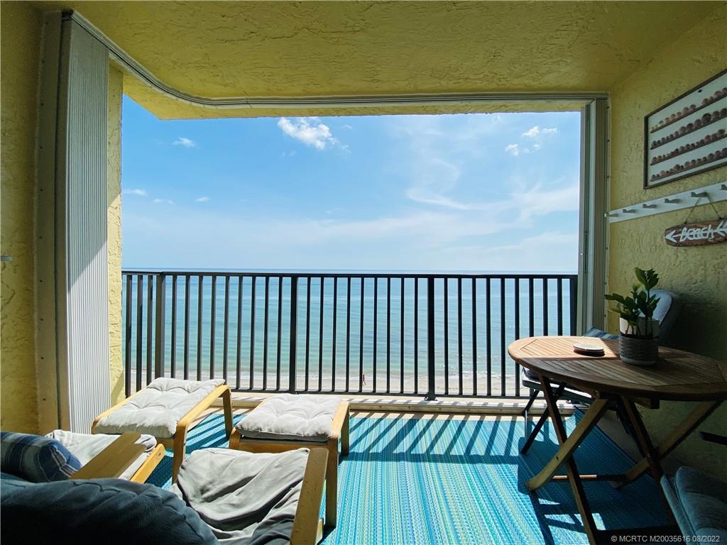 7380 South Ocean Drive, Unit 718A Jensen Beach, FL 34957 - Photo 20 of 58 a balcony with table and chairs