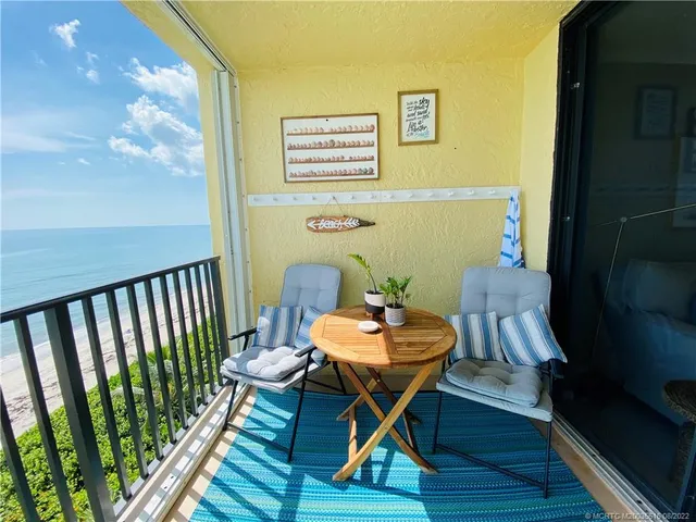 a balcony view with a seating space