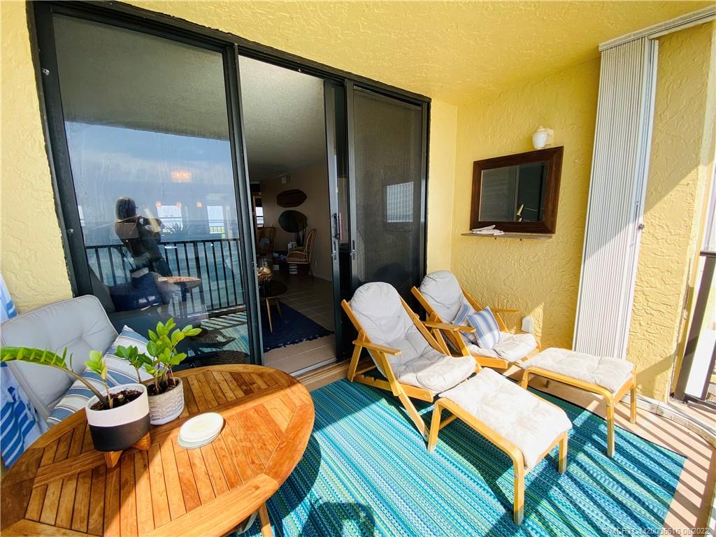 7380 South Ocean Drive, Unit 718A Jensen Beach, FL 34957 - Photo 25 of 58 a living room with patio furniture and a flat screen tv
