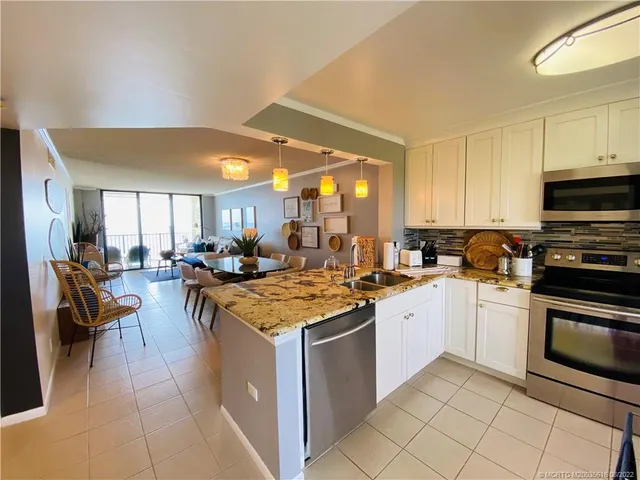 a kitchen with a stove a sink and a microwave