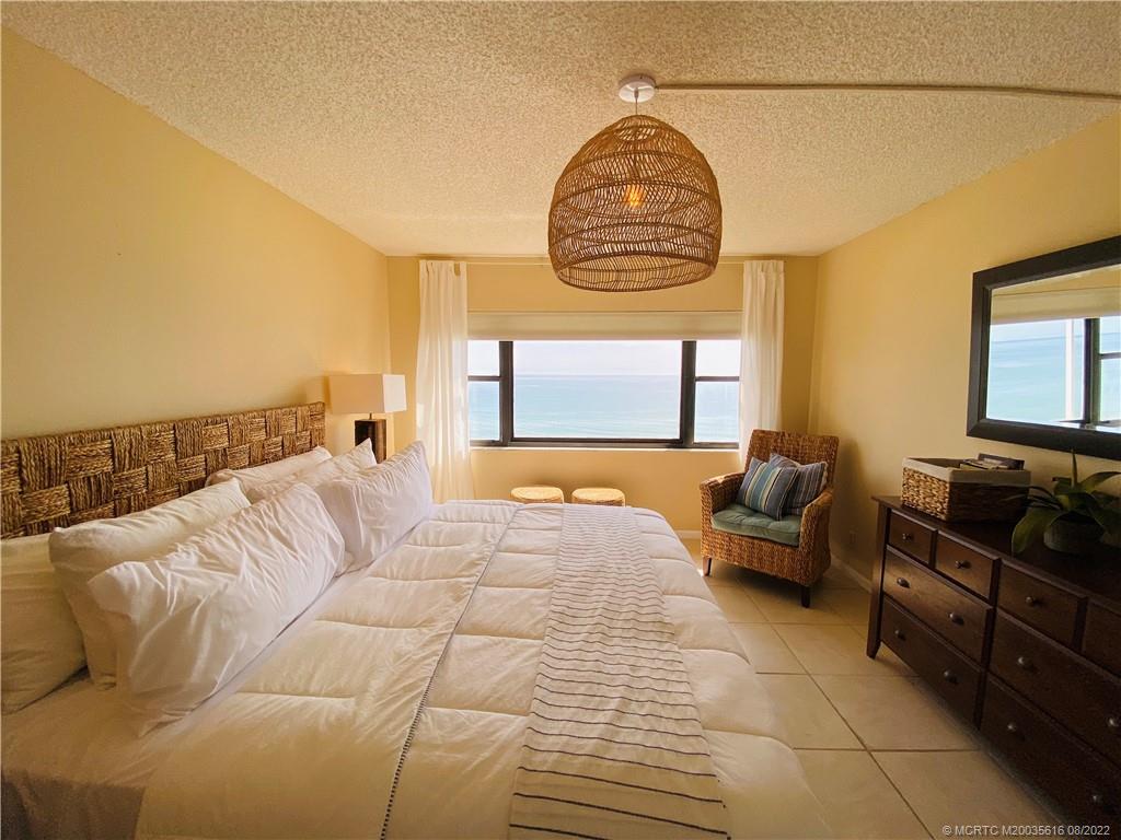 7380 South Ocean Drive, Unit 718A Jensen Beach, FL 34957 - Photo 34 of 58 a spacious bedroom with a bed and a flat screen tv