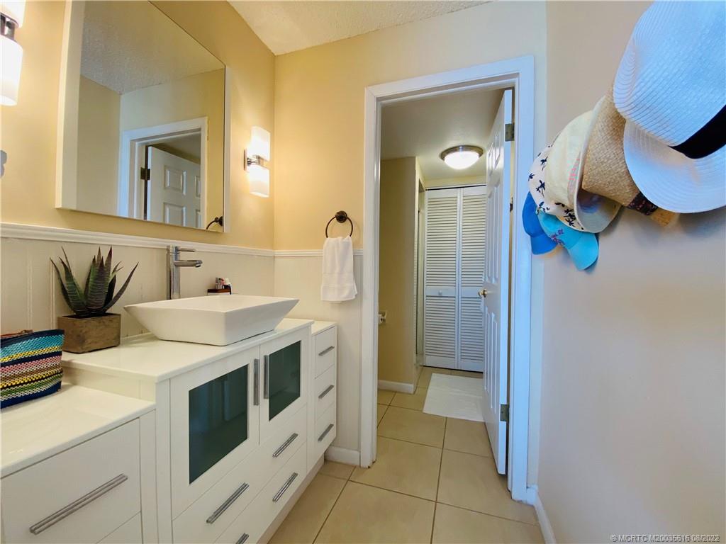 7380 South Ocean Drive, Unit 718A Jensen Beach, FL 34957 - Photo 35 of 58 a bathroom with a sink and mirror