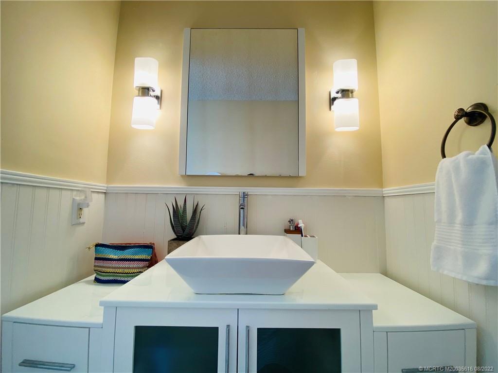 7380 South Ocean Drive, Unit 718A Jensen Beach, FL 34957 - Photo 36 of 58 a kitchen with a sink and a mirror