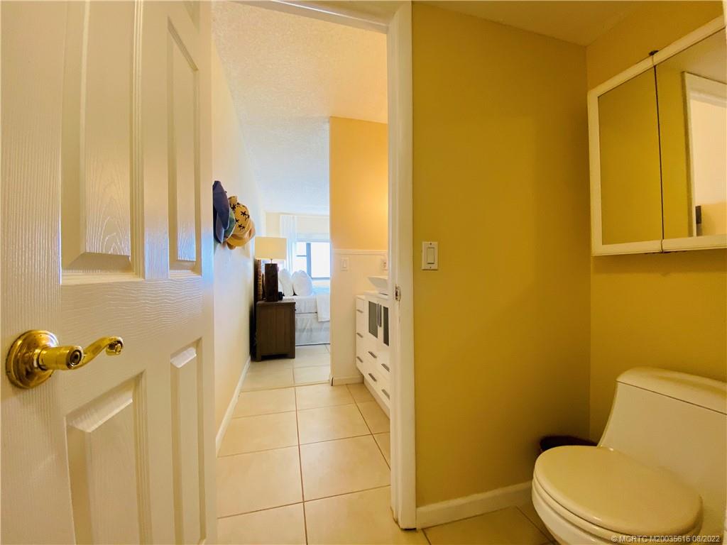 7380 South Ocean Drive, Unit 718A Jensen Beach, FL 34957 - Photo 39 of 58 a bathroom with a toilet and a shower