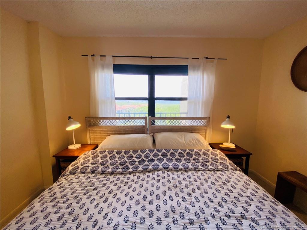 7380 South Ocean Drive, Unit 718A Jensen Beach, FL 34957 - Photo 43 of 58 a bedroom with a bed and a window