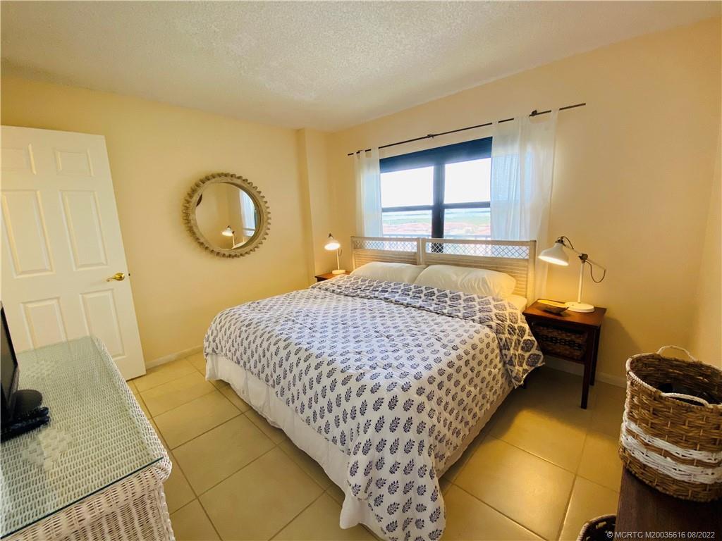 7380 South Ocean Drive, Unit 718A Jensen Beach, FL 34957 - Photo 45 of 58 a bedroom with a bed and a window