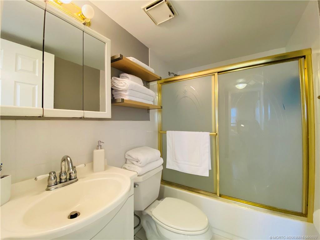 7380 South Ocean Drive, Unit 718A Jensen Beach, FL 34957 - Photo 46 of 58 a bathroom with a sink mirror toilet and shower