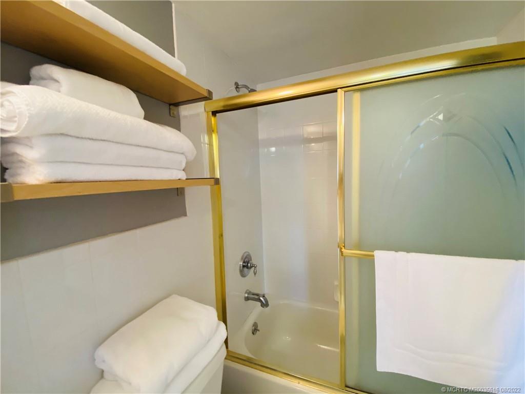 7380 South Ocean Drive, Unit 718A Jensen Beach, FL 34957 - Photo 47 of 58 a bathroom with a shower and a toilet