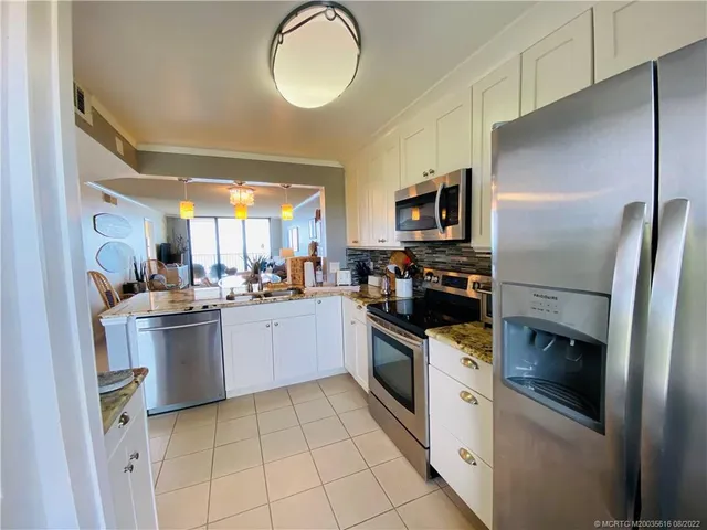 a kitchen with a sink stove and microwave