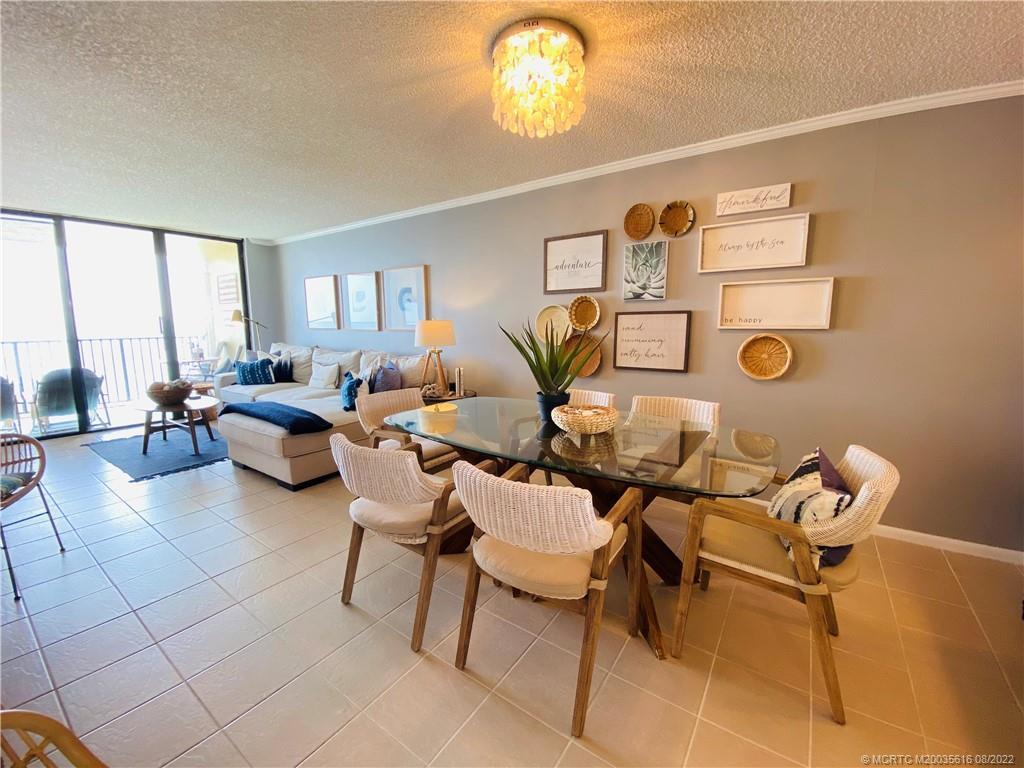 7380 South Ocean Drive, Unit 718A Jensen Beach, FL 34957 - Photo 10 of 58 a living room with furniture and a large window