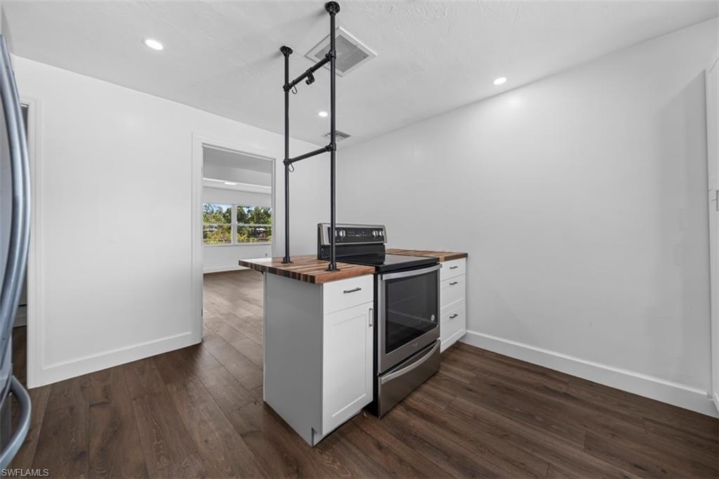 5460 Bayshore Road North Fort Myers, FL 33917 - Photo 9 of 14 a kitchen with stove and wooden floor