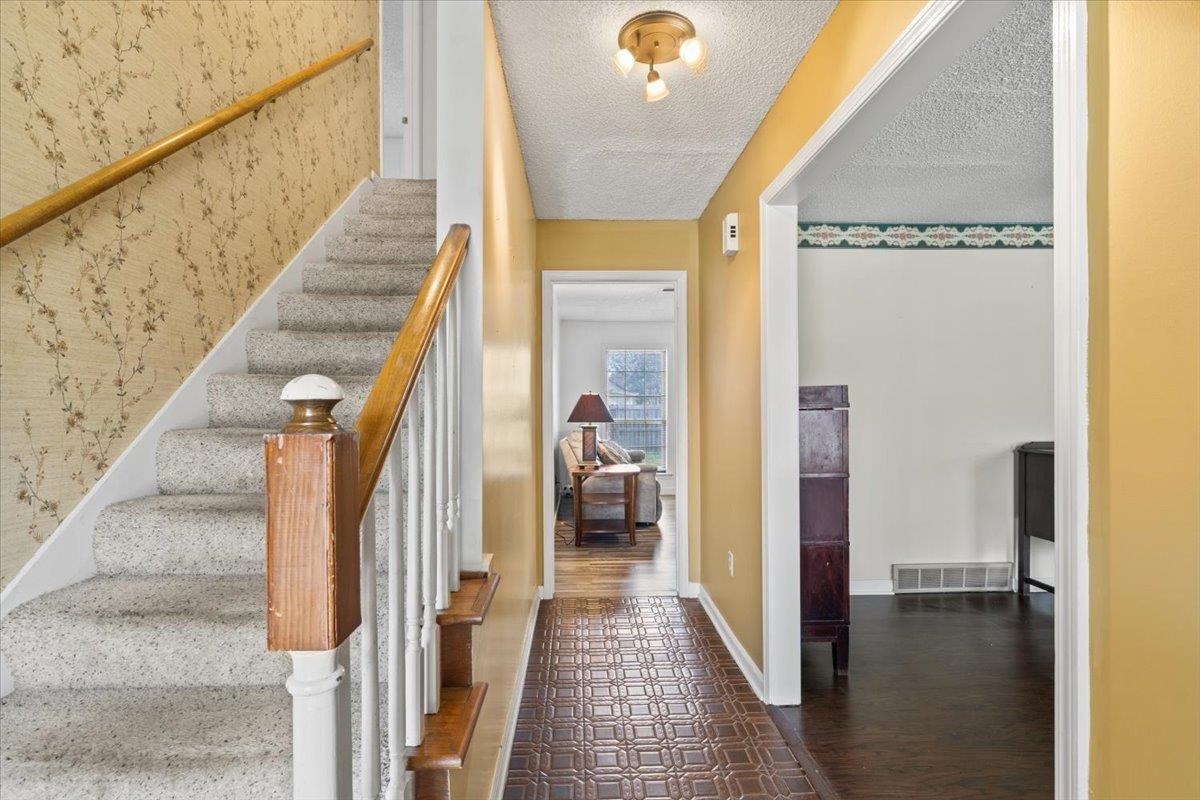 676 Hermitage Trail Collierville, TN 38017 - Photo 2 of 15 a view of a hallway with wooden floor and staircase