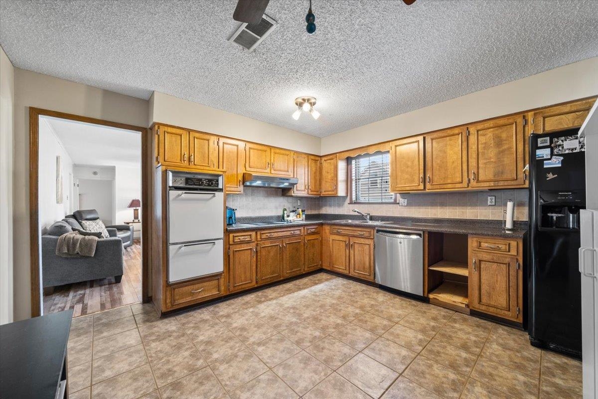676 Hermitage Trail Collierville, TN 38017 - Photo 5 of 15 a kitchen with sink a refrigerator and cabinets