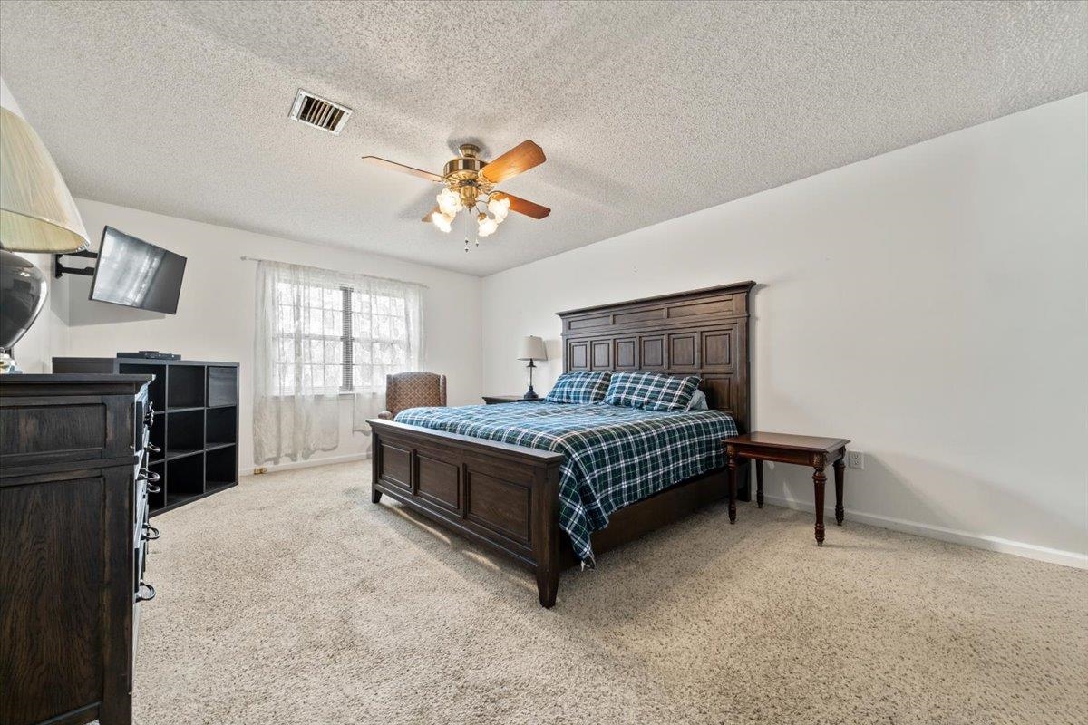 676 Hermitage Trail Collierville, TN 38017 - Photo 8 of 15 a bedroom with a bed and a chandelier