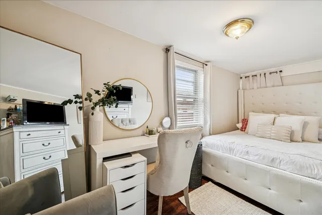 a bedroom with a bed a stove and a flat screen tv