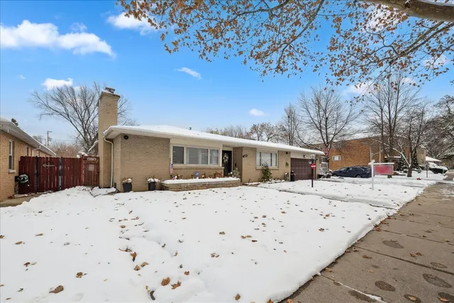 a view of a house with snow on the road
