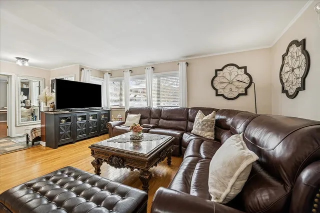 a living room with furniture and a clock