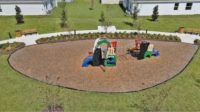an aerial view of a house with outdoor space patio and outdoor seating