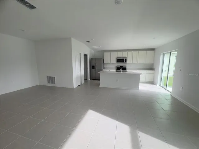 a view of a kitchen with a sink cabinets and a refrigerator