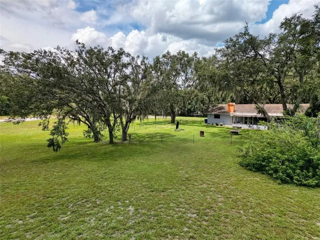 an aerial view of lake residential house with swimming pool and outdoor space