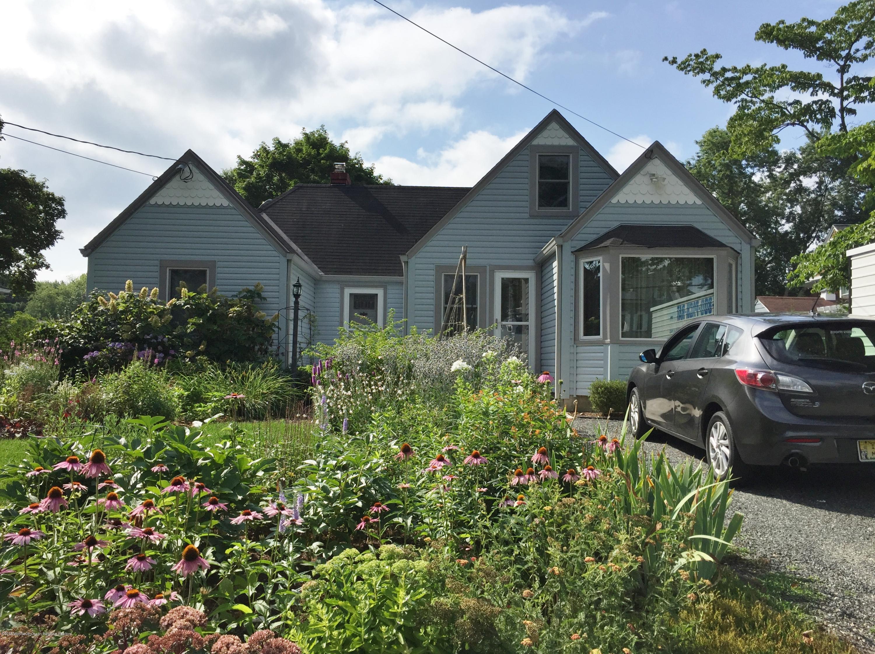12 Little Silver Point Road Little Silver, NJ 07739 - Photo 1 of 29 a front view of a house with a yard and potted plants