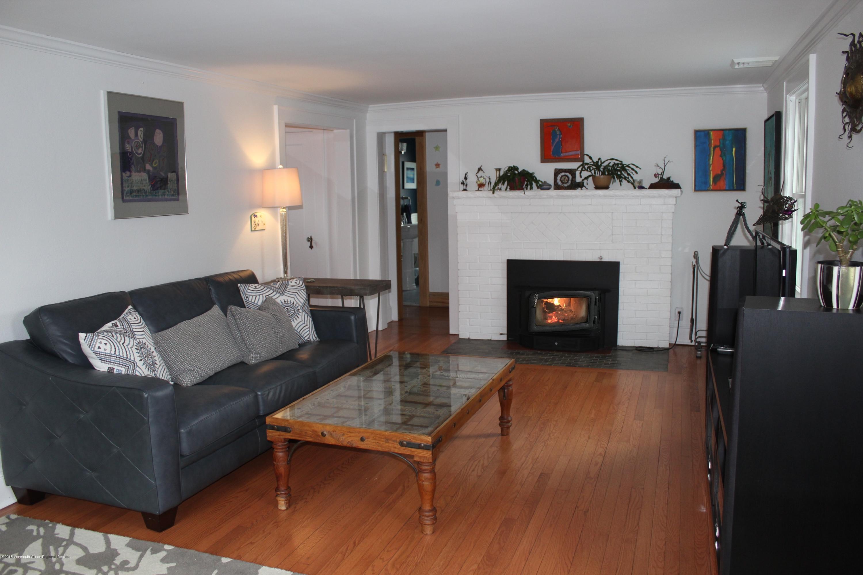 12 Little Silver Point Road Little Silver, NJ 07739 - Photo 2 of 29 a living room with furniture and a fireplace