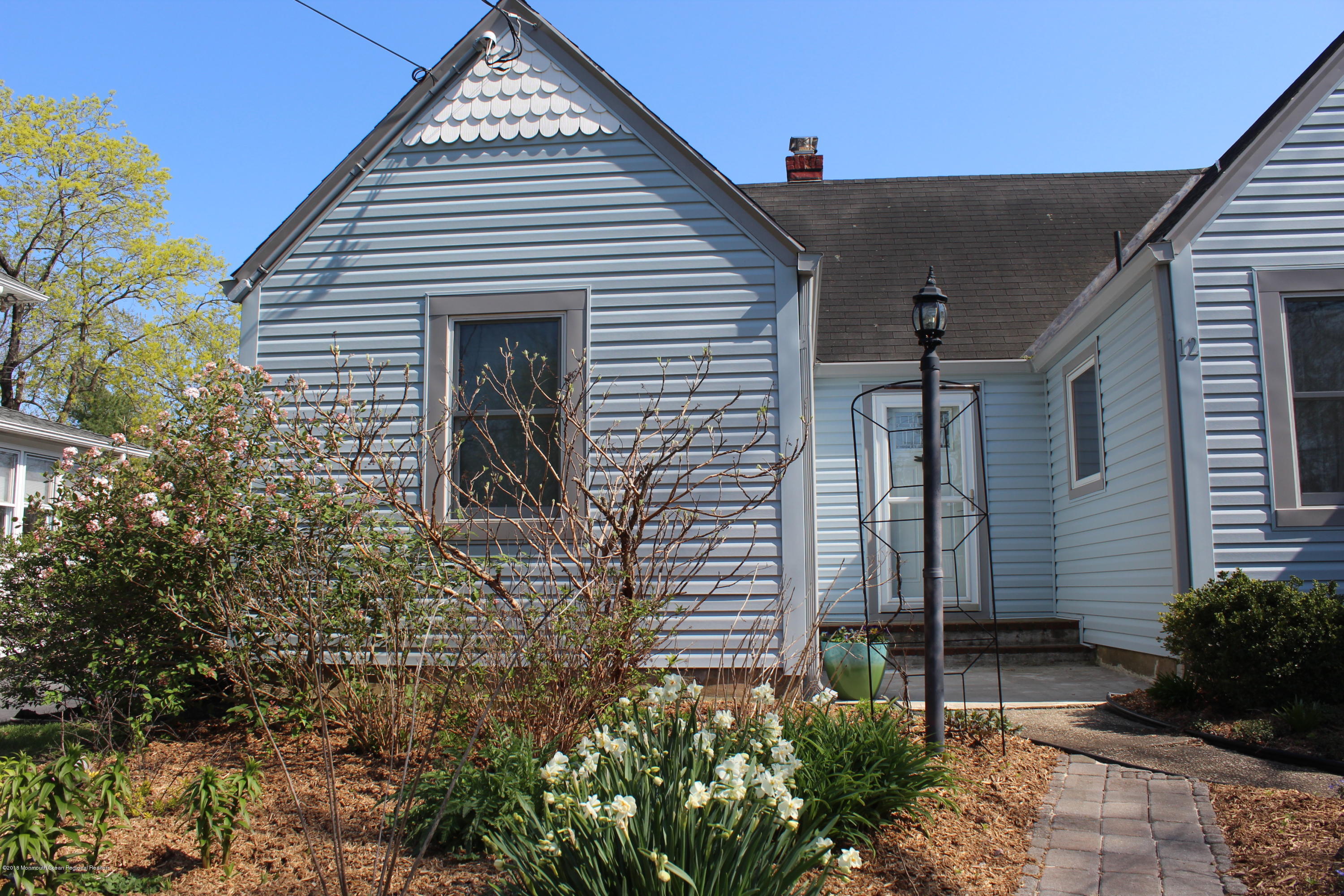 12 Little Silver Point Road Little Silver, NJ 07739 - Photo 26 of 29 a front view of a house with garden