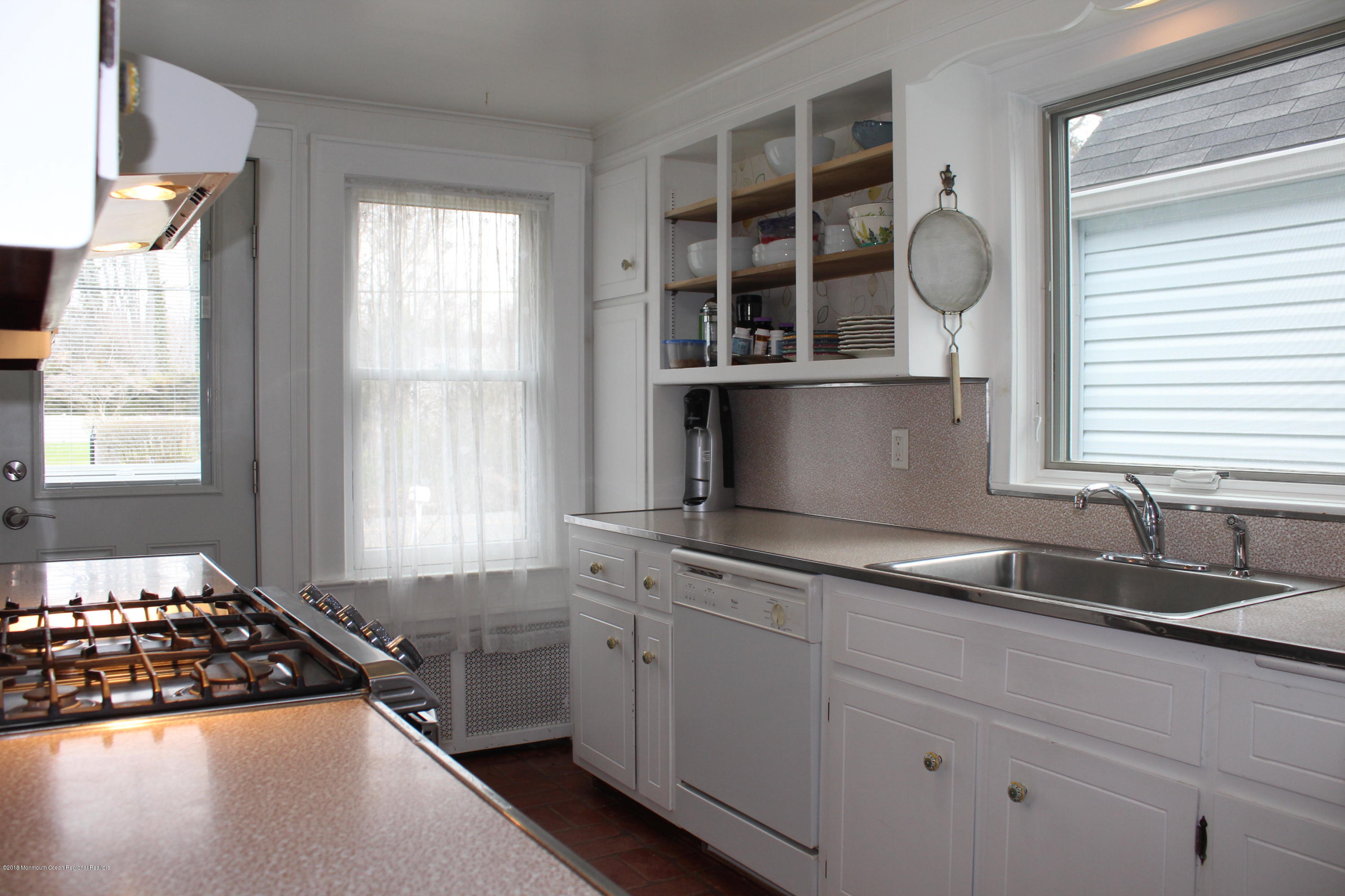 12 Little Silver Point Road Little Silver, NJ 07739 - Photo 10 of 29 a kitchen with cabinets appliances and a window