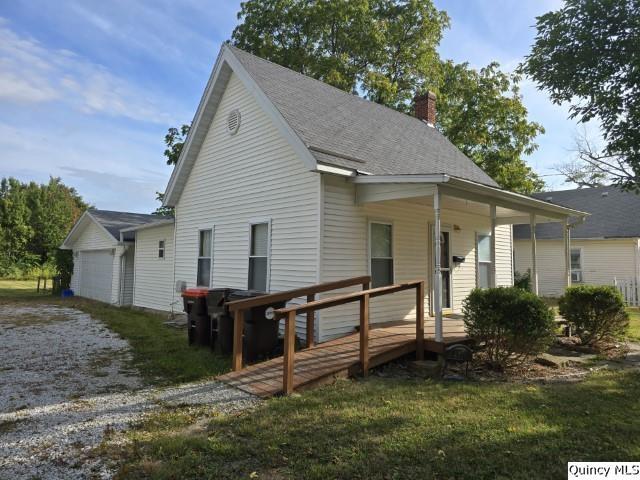 729 Buchanan Street Carthage, IL 62321 - Photo 14 of 16 a view of a house with a yard chairs and wooden fence