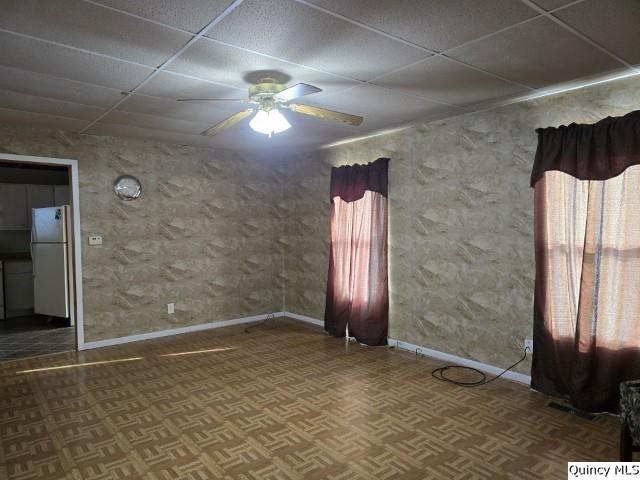 729 Buchanan Street Carthage, IL 62321 - Photo 2 of 16 en empty room with windows and chandelier fan