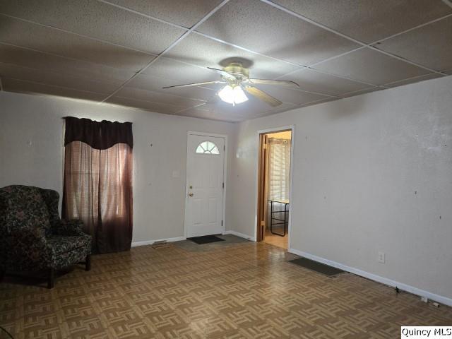 729 Buchanan Street Carthage, IL 62321 - Photo 3 of 16 a view of an empty room with a ceiling fan and a window