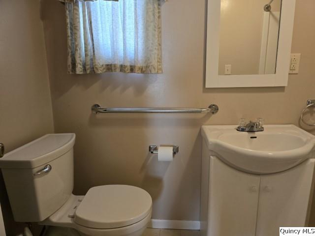 729 Buchanan Street Carthage, IL 62321 - Photo 9 of 16 a bathroom with a sink a toilet and a mirror