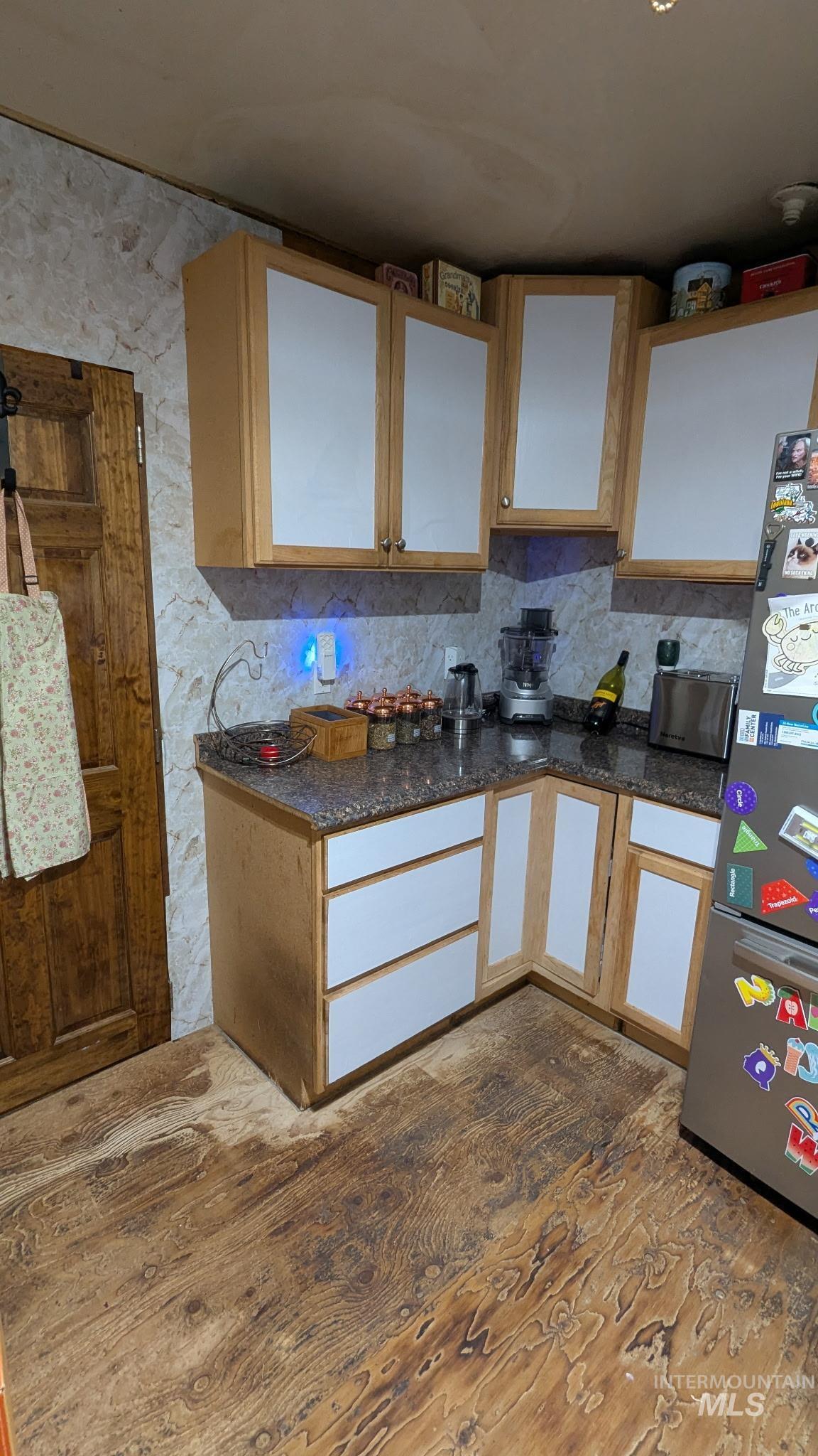 411 South Pine Street Troy, ID 83871 - Photo 6 of 10 Two tone kitchen featuring freestanding refrigerator and two tone cabinetry