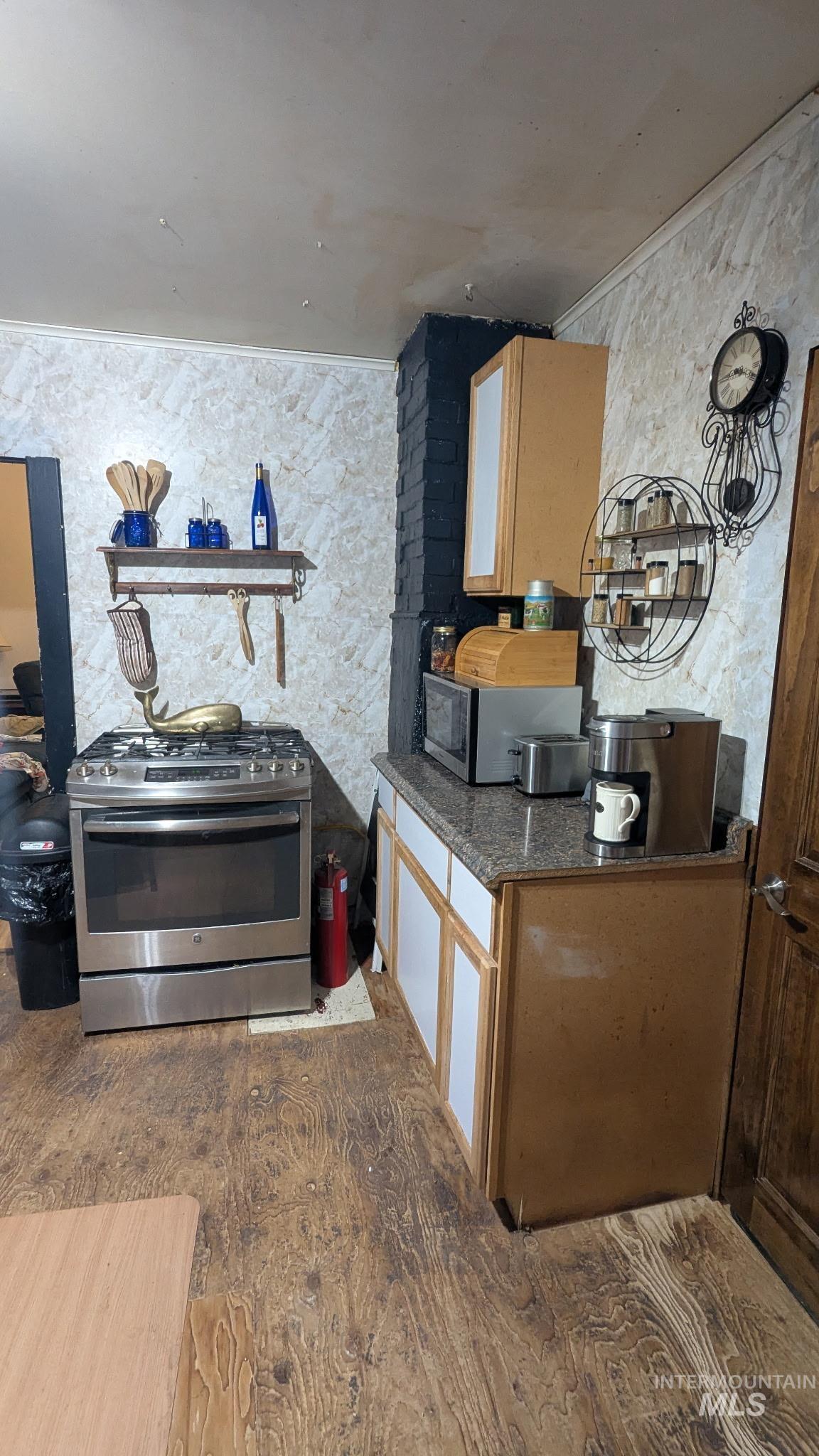 411 South Pine Street Troy, ID 83871 - Photo 7 of 10 Kitchen with stainless steel appliances, dark stone counters, and wood finish cabinets