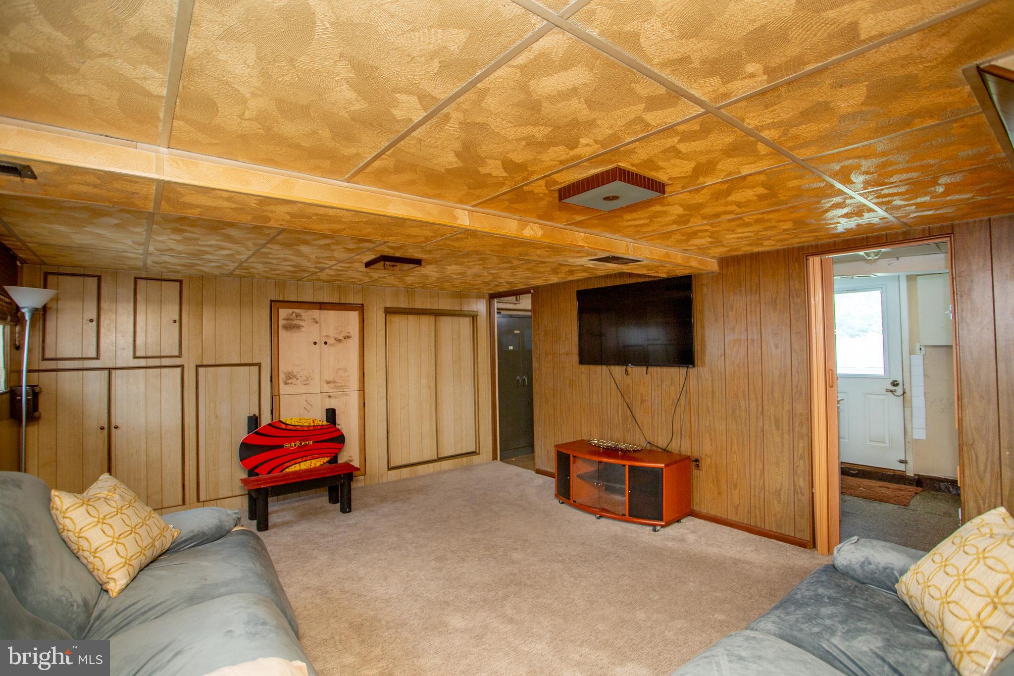 1264 Tulip Road Warminster, PA 18974 - Photo 11 of 21 a living room with furniture a flat screen tv and gym equipment