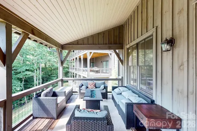a balcony with furniture and wooden floor