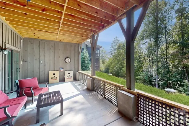 a balcony with furniture and next to a yard