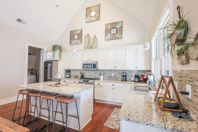 a kitchen with a sink stove and cabinets