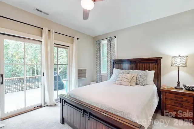 a bedroom with a bed and a large window