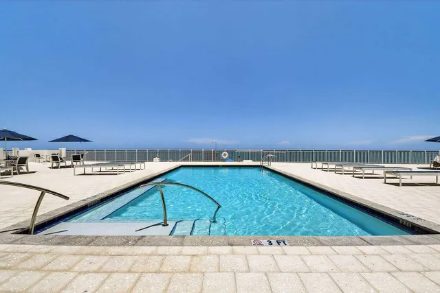 a view of a swimming pool and an outdoor seating