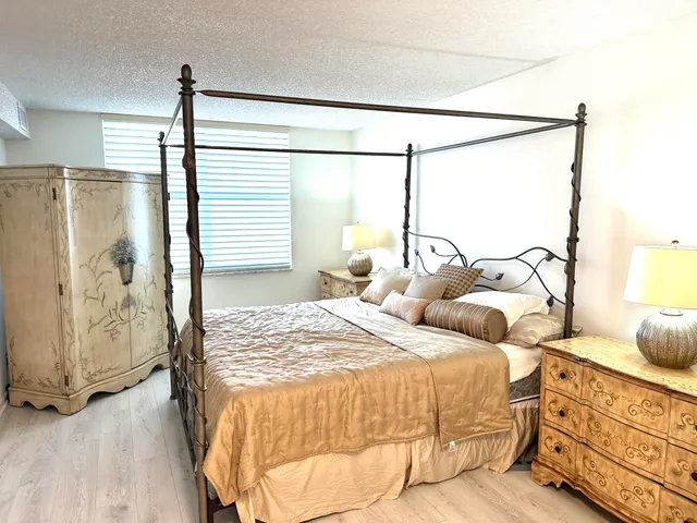 a bedroom with double bed and a window