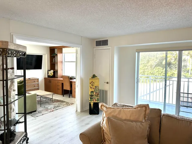 a living room with furniture window and wooden floor