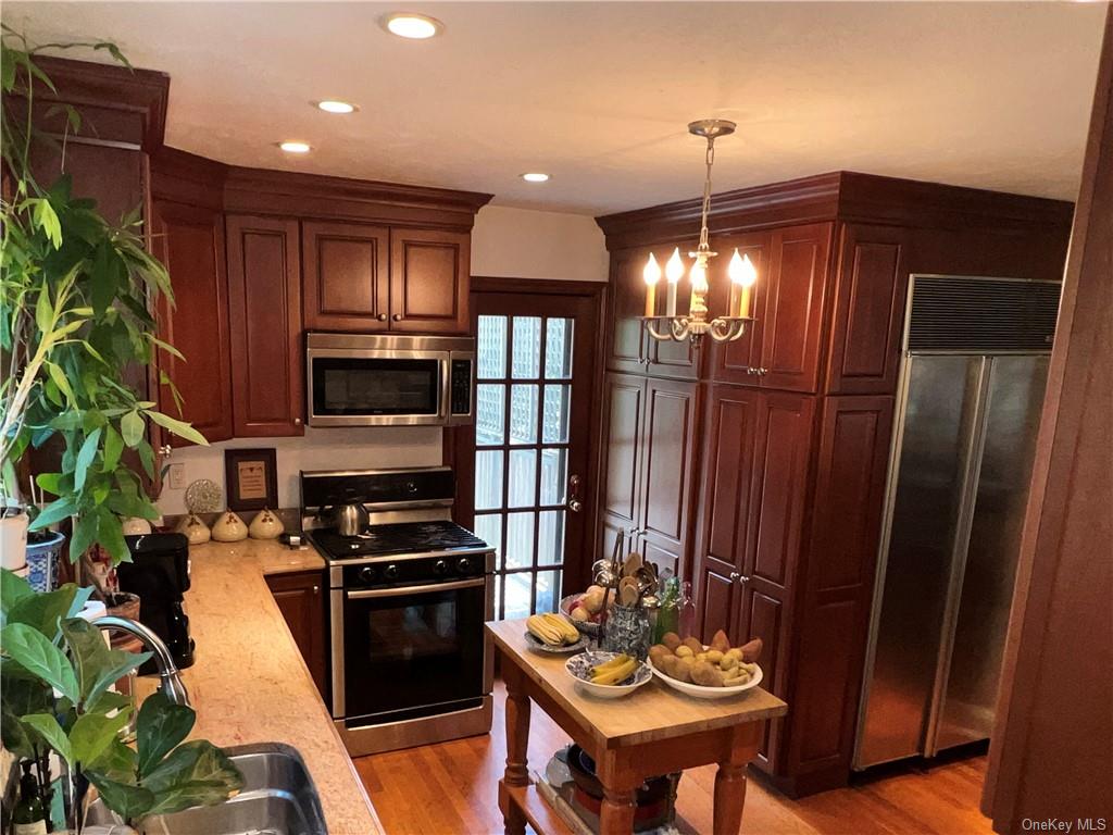 202 Garden Road Larchmont, NY 10538 - Photo 12 of 19 a kitchen with stainless steel appliances kitchen island granite countertop a refrigerator a stove a sink and a microwave