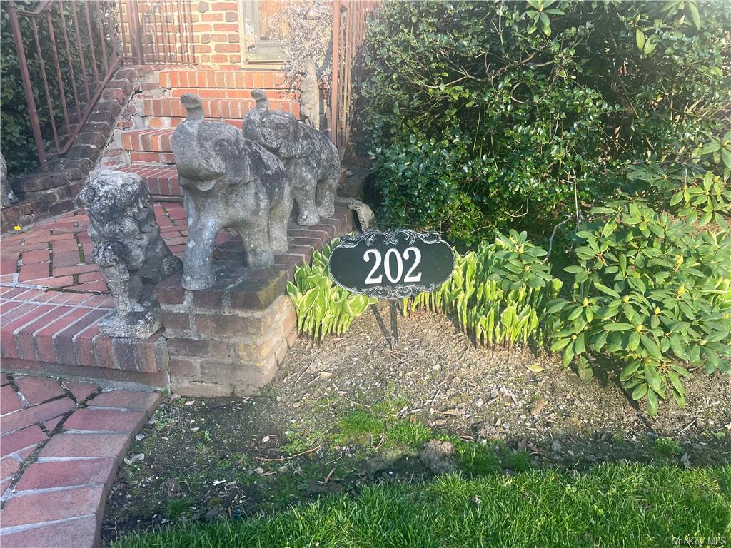 202 Garden Road Larchmont, NY 10538 - Photo 3 of 19 a sign that is sitting on a brick wall
