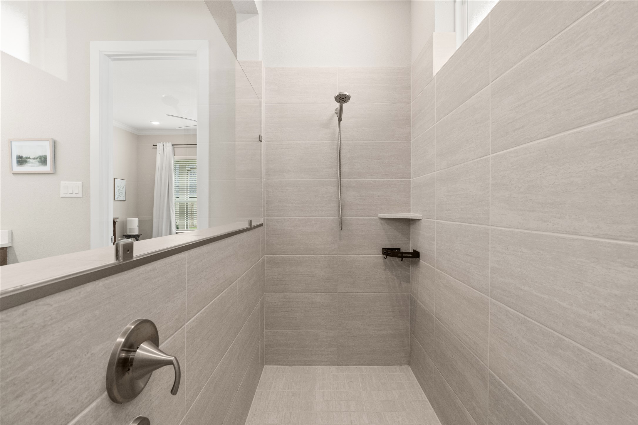 3118 Swift Way Katy, TX 77493 - Photo 21 of 34 Primary Bathroom (Shower) – Walk-in tiled shower with clean, contemporary finishes and built-in shelving for convenience.