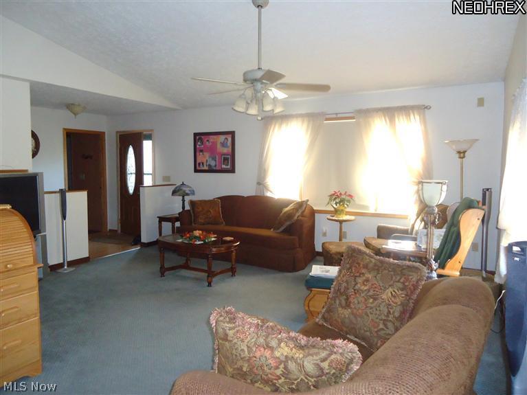 4315 Mayfair Road Uniontown, OH 44685 - Photo 4 of 25 Vaulted family room that has plenty of natural lighting with multiple windows.