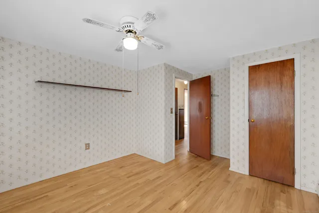 a view of a livingroom with a chandelier fan