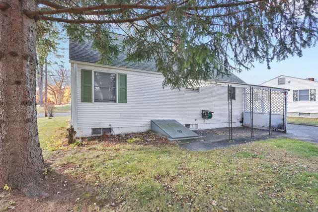 a backyard of a house with table and chairs