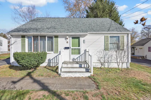 a view of house with outdoor seating area