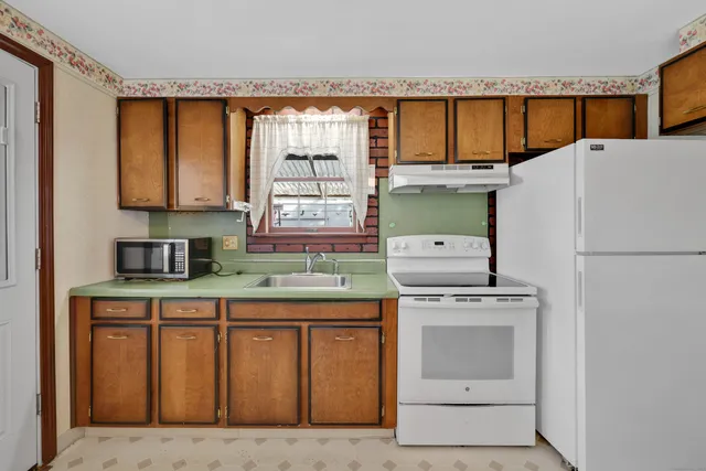a kitchen with a stove a refrigerator and a sink